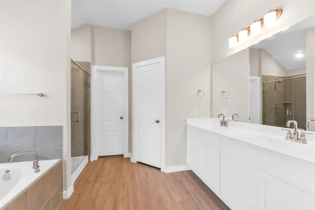 a bathroom with a tub sink and mirror
