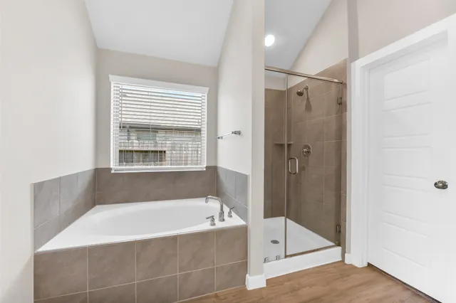 a bathroom with a bathtub and a shower