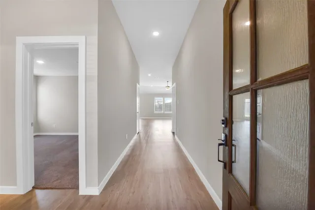 a view of hallway with wooden floor
