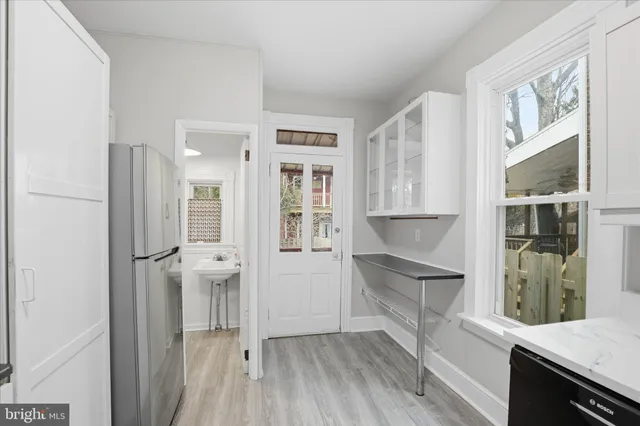 a kitchen with stainless steel appliances granite countertop a refrigerator and a sink