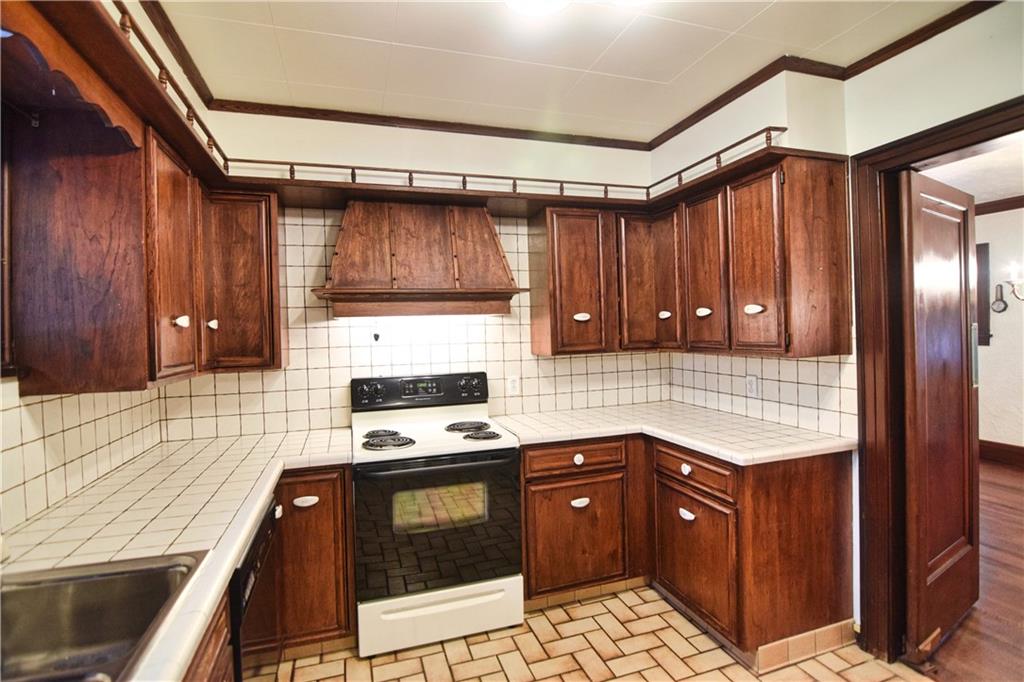 3765 Highway 257 Seneca, PA 16346 - Photo 11 of 42 a kitchen with granite countertop a stove a sink and a microwave