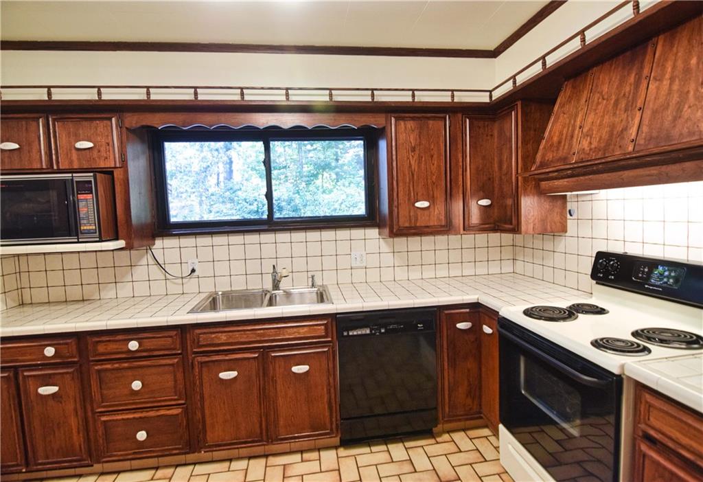 3765 Highway 257 Seneca, PA 16346 - Photo 13 of 42 a kitchen with granite countertop a sink stove and cabinets
