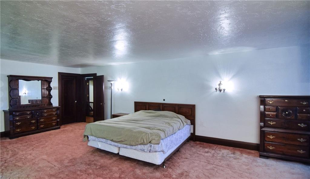 3765 Highway 257 Seneca, PA 16346 - Photo 18 of 42 a bedroom with a bed and a dresser