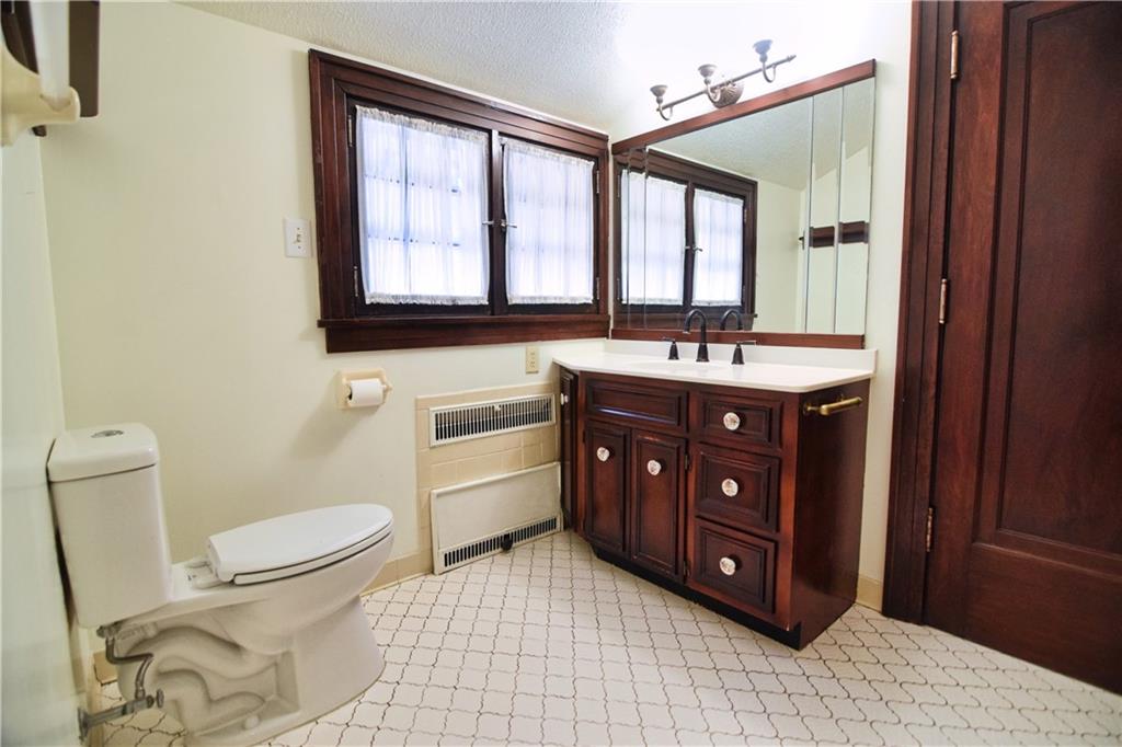 3765 Highway 257 Seneca, PA 16346 - Photo 8 of 42 a bathroom with a sink vanity mirror and toilet