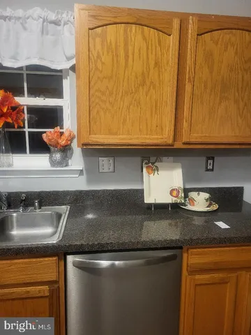 a kitchen with stainless steel appliances granite countertop a sink and a stove