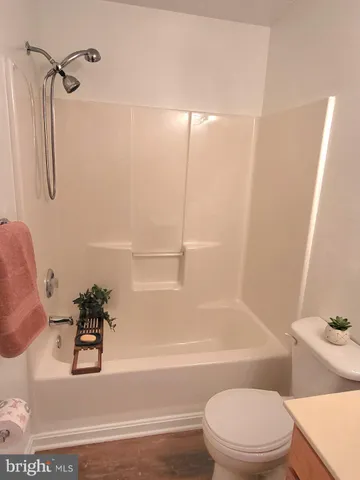 a view of walk in closet with clothes