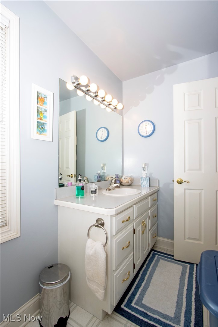 10050 Mennonite Road Rittman, OH 44270 - Photo 17 of 42 Bathroom featuring vanity, tile patterned flooring, and baseboards