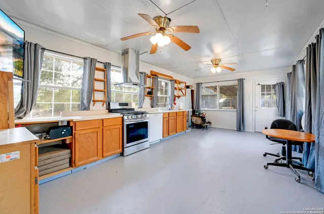 a view of a livingroom with furniture and a kitchen