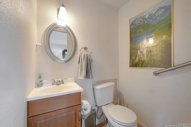 a bathroom with a toilet a sink and a mirror