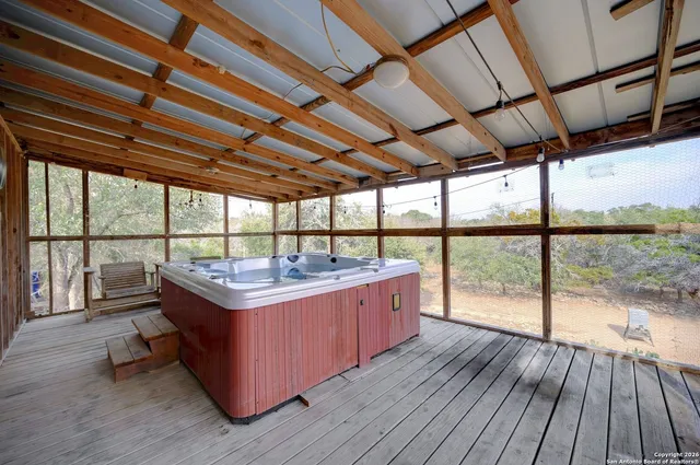 a view of a room with wooden floor and outdoor space