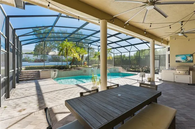 a view of a patio with a table and chairs under an umbrella