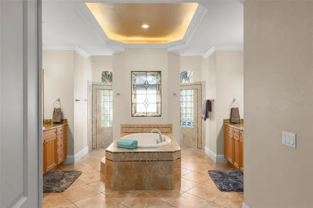 a spacious bathroom with a granite countertop tub sink and mirror