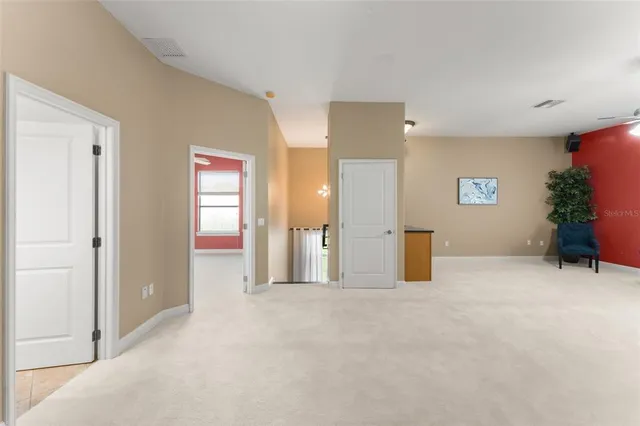 an empty room with a ceiling fan and a window