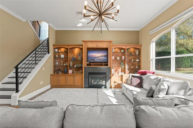 a living room with furniture and flat screen tv