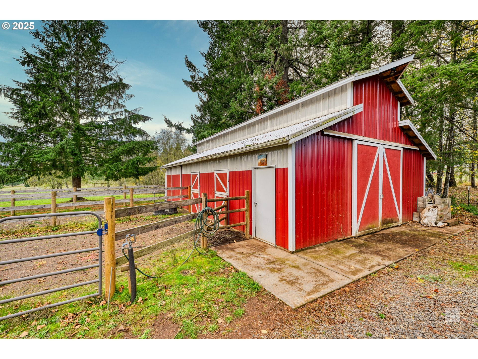 37902 Southeast Porter Road Estacada, OR 97023 - Photo 30 of 48 a view of a backyard with large trees and wooden fence
