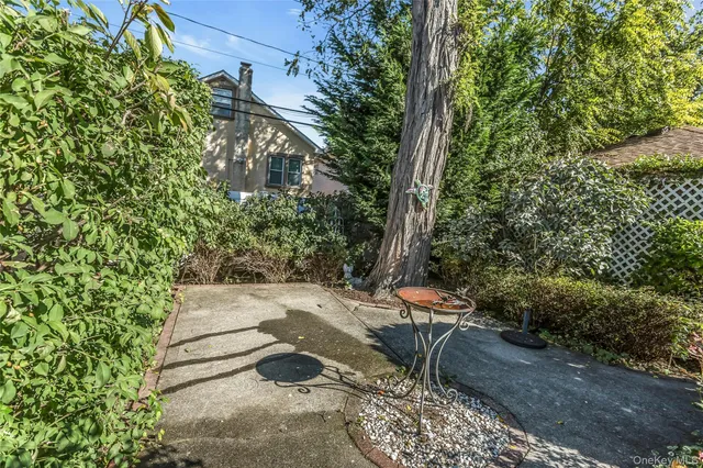 a backyard of a house with table and chairs