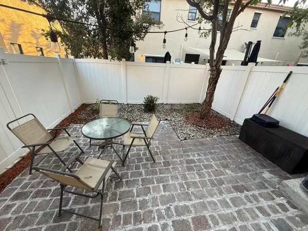 a backyard of a house with table and chairs