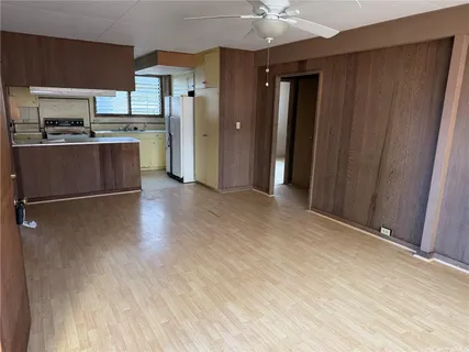 a view of a kitchen with a sink and a refrigerator