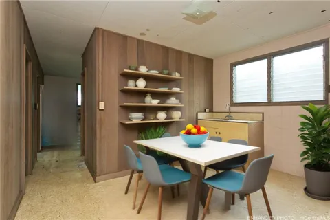 a view of a dining room with furniture and window