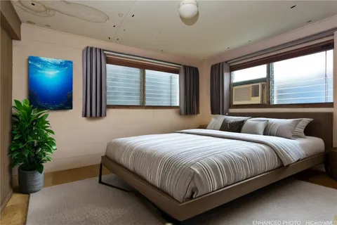 a bedroom with a bed lamp and a potted plant