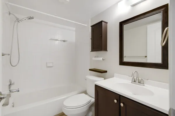 a view of bathroom with a toilet a sink and mirror