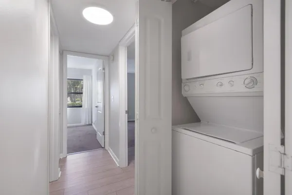 a view of a kitchen with a sink and refrigerator