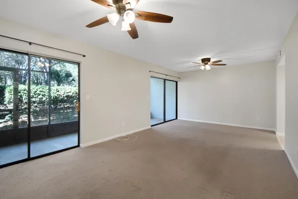 a view of a livingroom with a ceiling fan and window