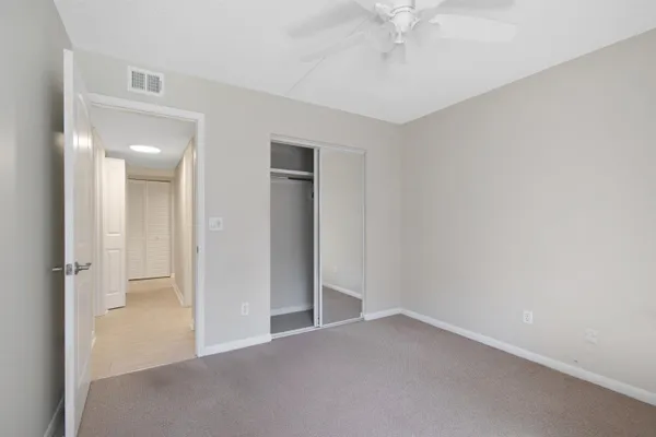 an empty room with chandelier fan