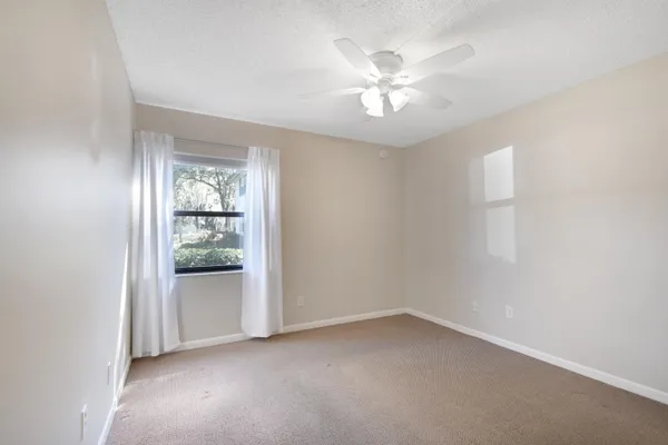 a view of an empty room with a fan