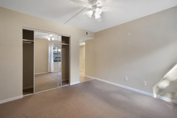 a bathroom with a granite countertop sink toilet a mirror and shower