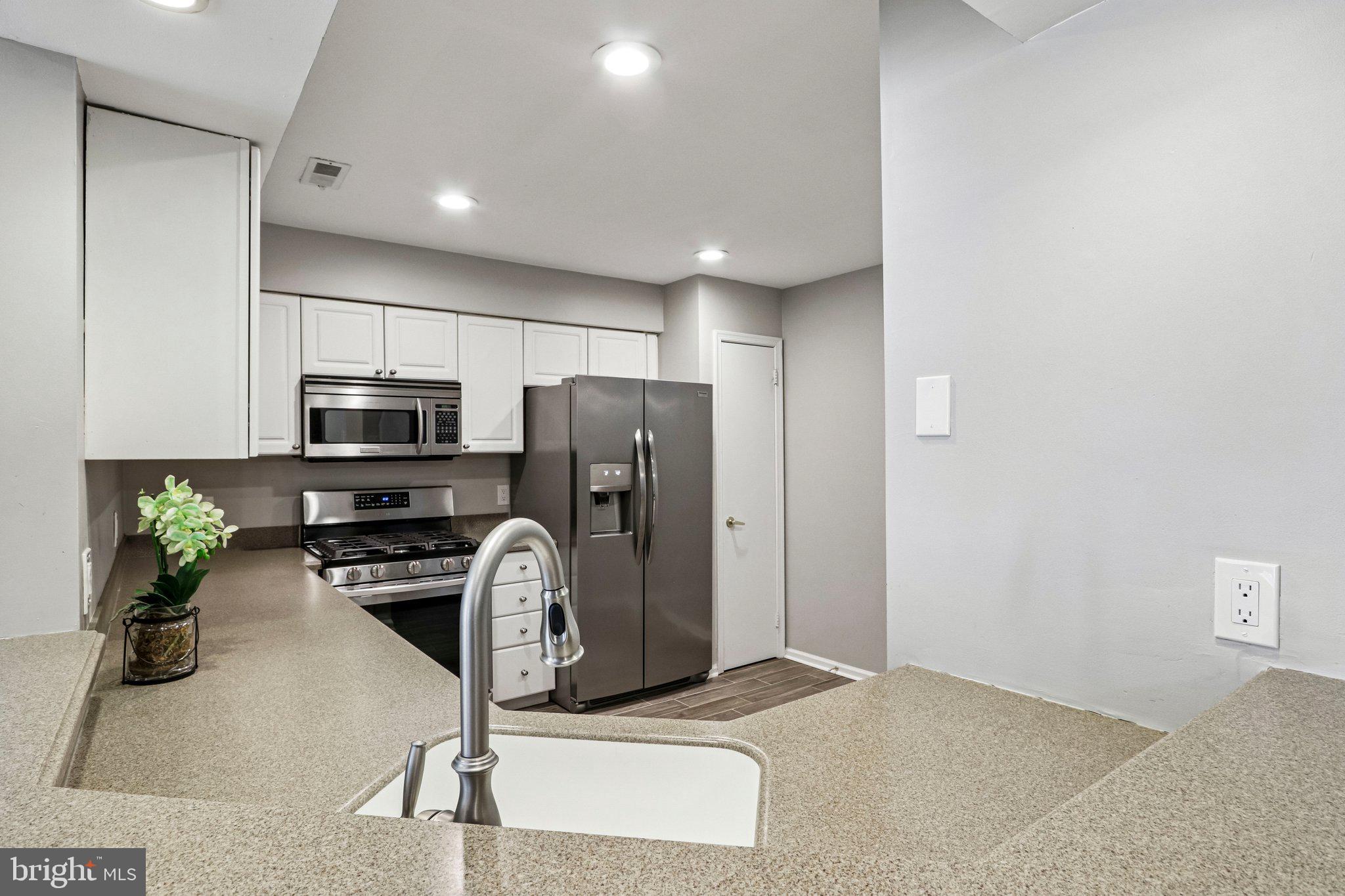 803 Wharton Road Mount Laurel, NJ 08054 - Photo 3 of 48 a kitchen with stainless steel appliances a stove a refrigerator a sink a microwave and cabinets