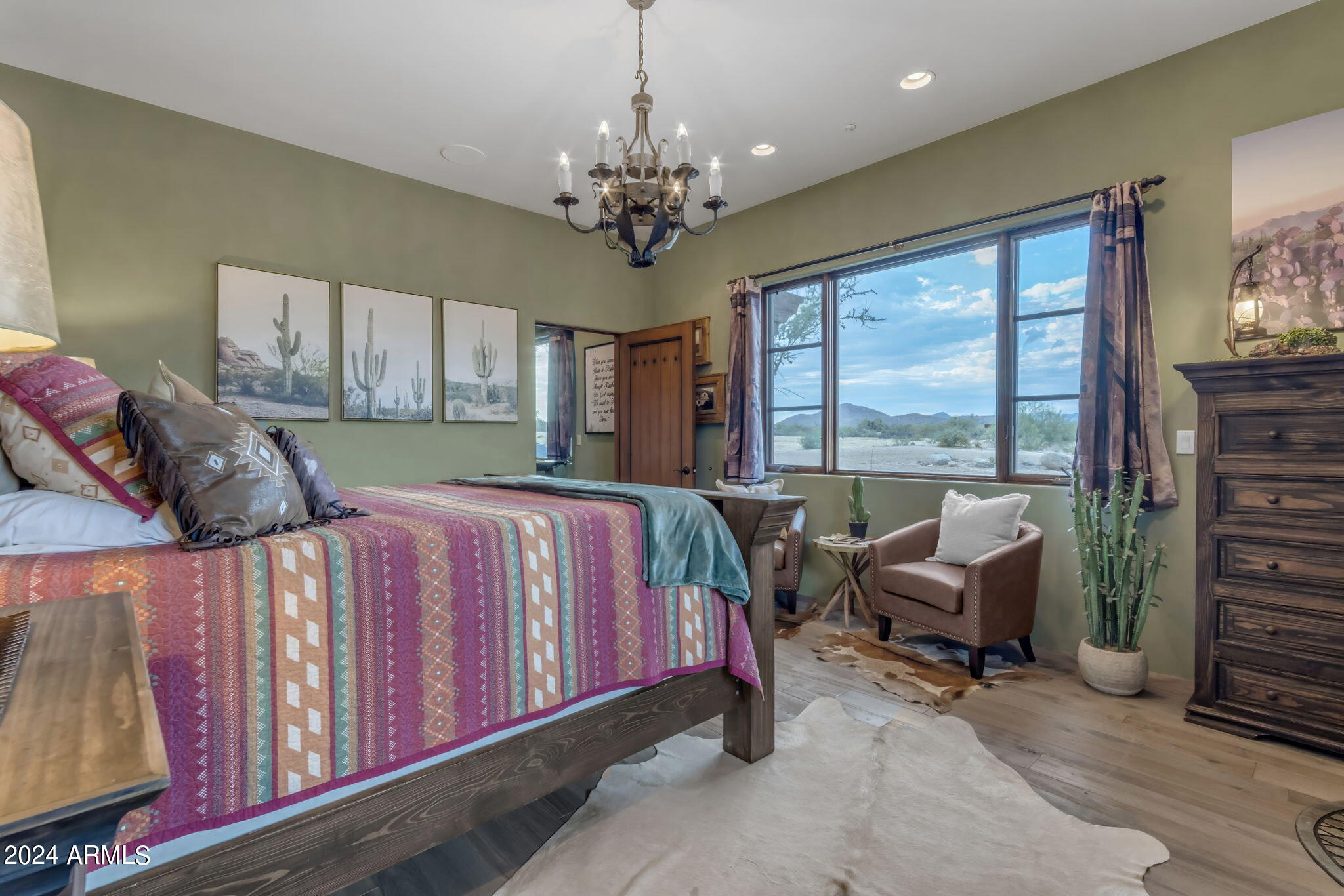 13330 East Jomax Road Scottsdale, AZ 85262 - Photo 133 of 164 a spacious bedroom with a bed and a chandelier
