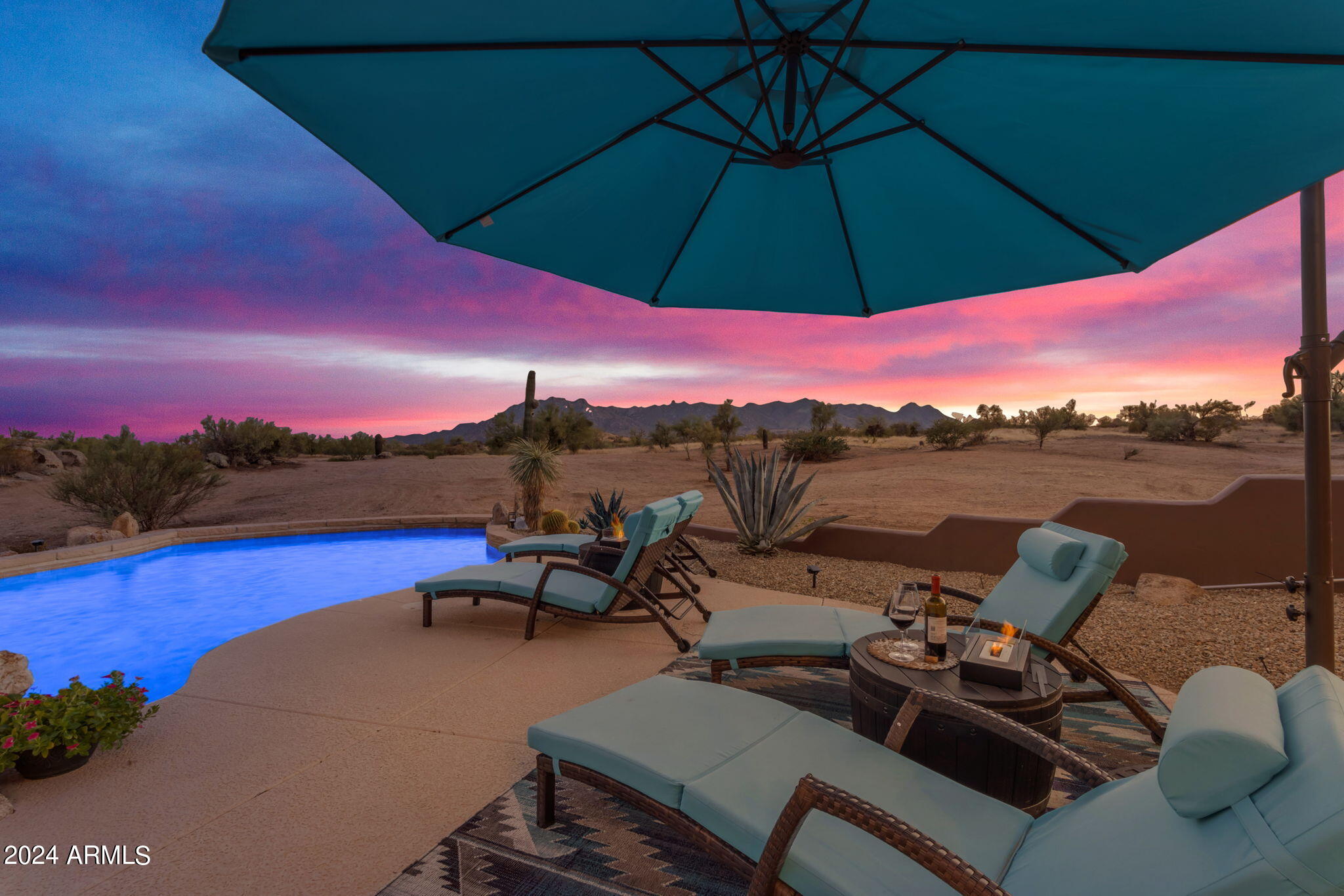 13330 East Jomax Road Scottsdale, AZ 85262 - Photo 33 of 164 a view of a patio with lawn chairs under an umbrella