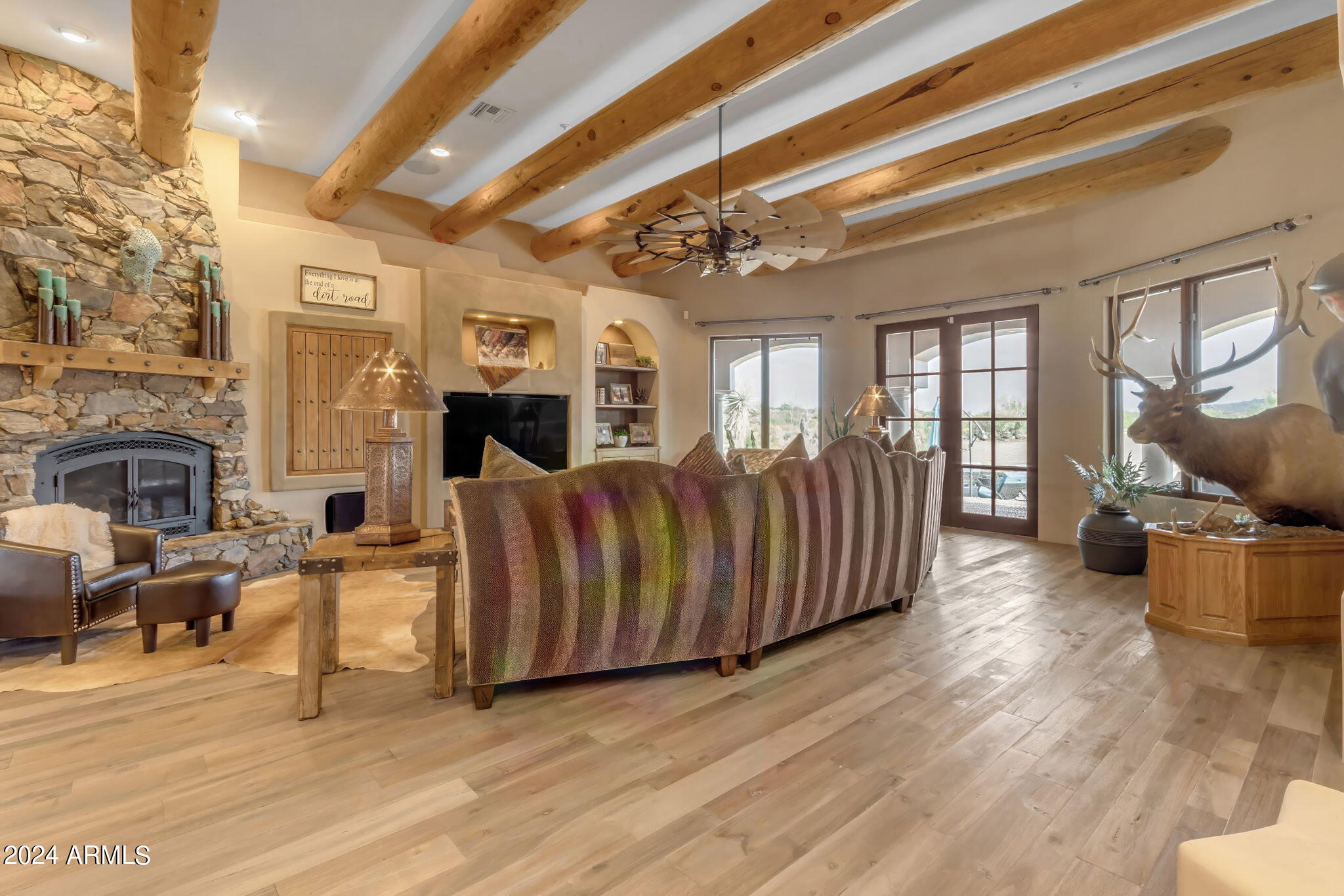 13330 East Jomax Road Scottsdale, AZ 85262 - Photo 100 of 164 a living room with furniture wooden floor and a fireplace