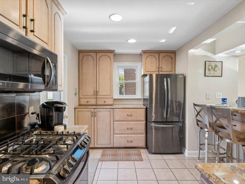 1723 Ridgeway Road Havertown, PA 19083 - Photo 16 of 35 a kitchen with granite countertop a stove and a refrigerator