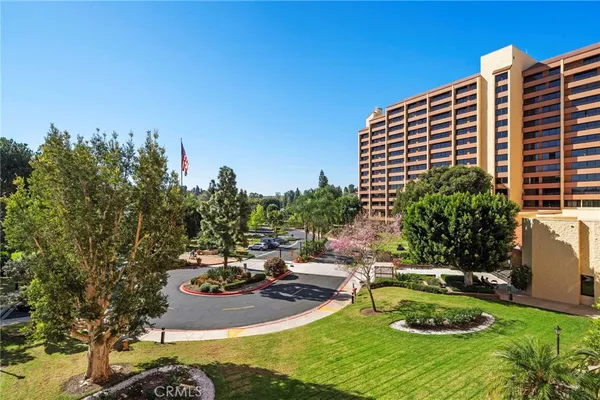 a view of a swimming pool with a patio and a yard