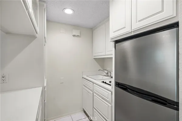 a kitchen with white cabinets and white appliances