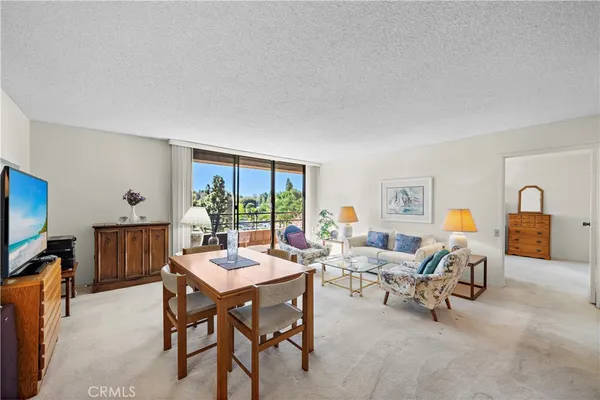 a view of a livingroom with furniture and a window