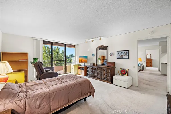 a bedroom with a large bed and a large window