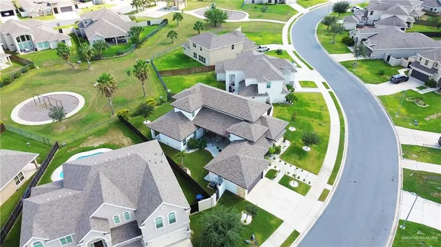 an aerial view of residential houses with outdoor space and swimming pool