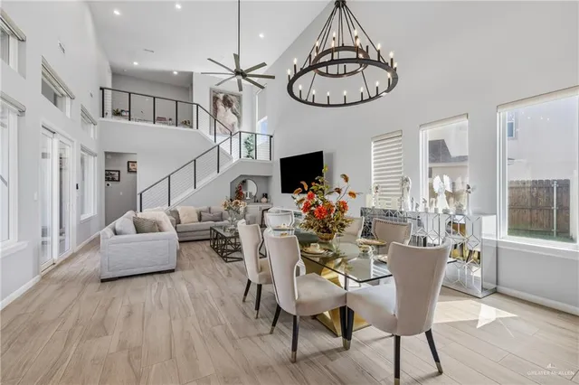 a view of a dining room with furniture a chandelier and wooden floor