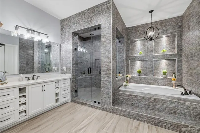 a spacious bathroom with a double vanity sink a mirror and a shower