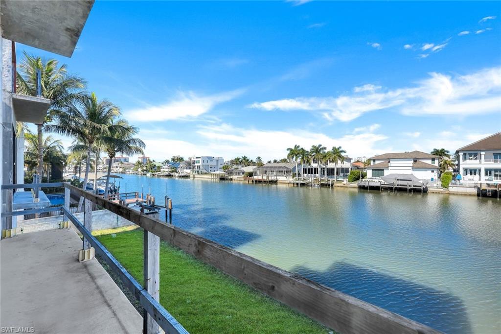 415 Seabee Avenue Naples, FL 34108 - Photo 14 of 32 a view of a lake with a city