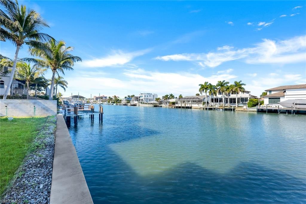 415 Seabee Avenue Naples, FL 34108 - Photo 16 of 32 a view of a lake with outdoor space