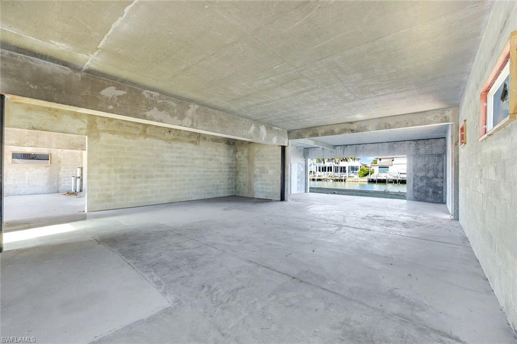 415 Seabee Avenue Naples, FL 34108 - Photo 18 of 32 a view of an empty room with a window and cars parked