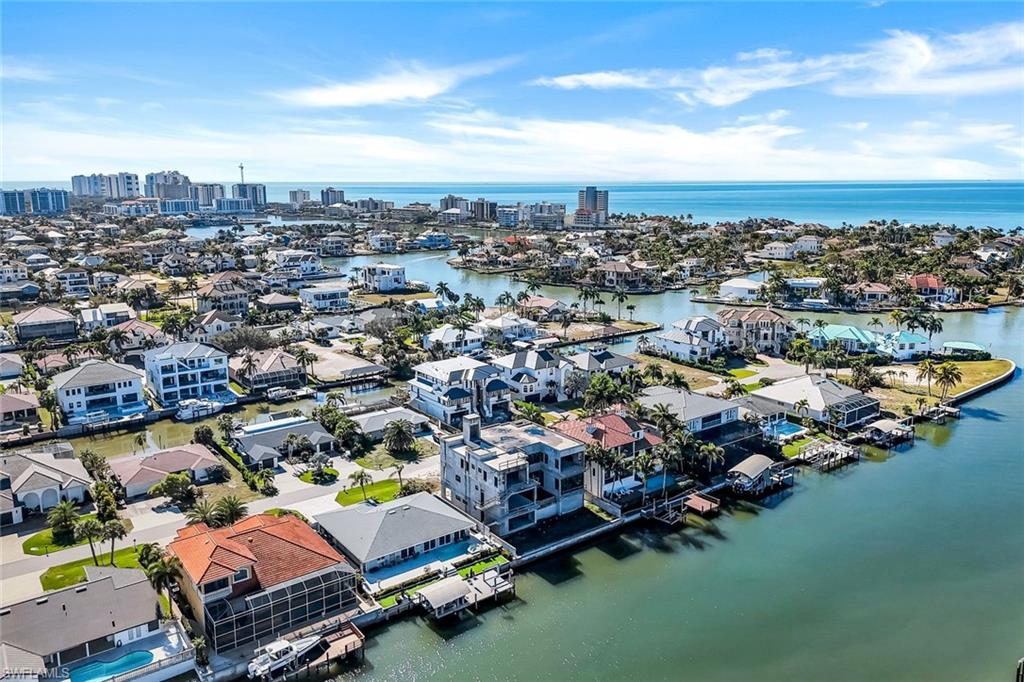 415 Seabee Avenue Naples, FL 34108 - Photo 21 of 32 an aerial view of a city with lots of residential buildings ocean and mountain view in back