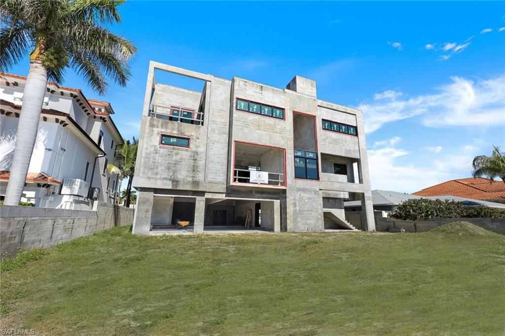 415 Seabee Avenue Naples, FL 34108 - Photo 5 of 32 a front view of a building with street