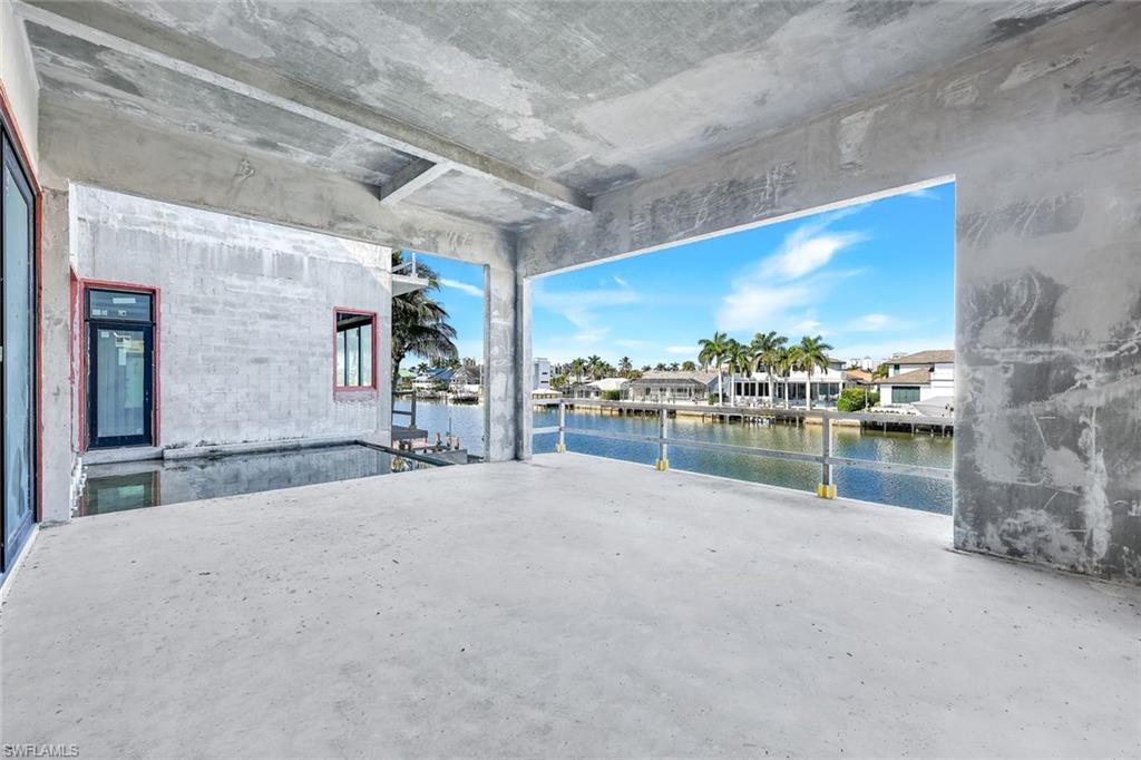 415 Seabee Avenue Naples, FL 34108 - Photo 9 of 32 a swimming pool with lake view