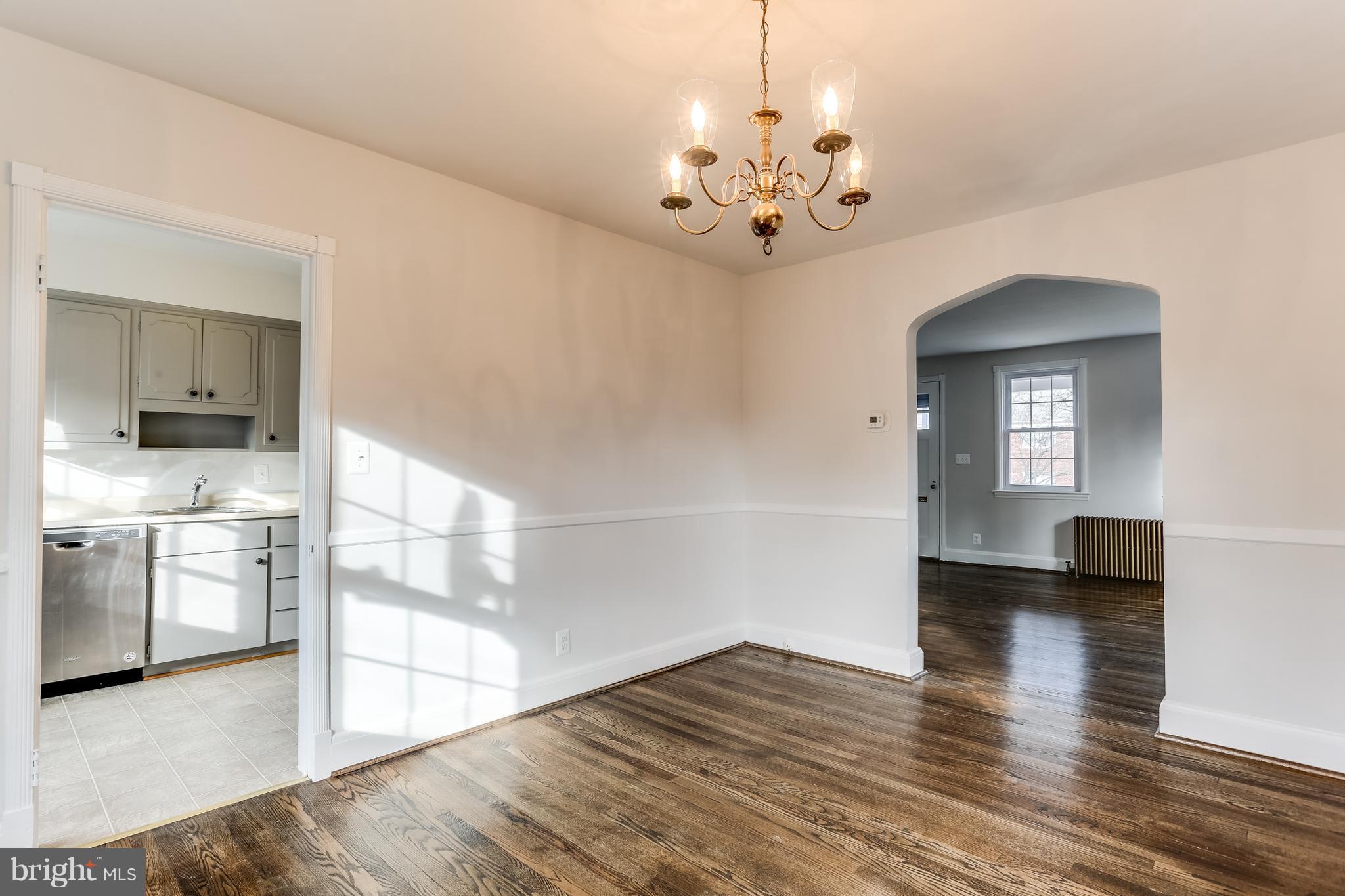 113 Murdock Road Baltimore, MD 21212 - Photo 14 of 21 a view of a hallway with wooden floor and a kitchen