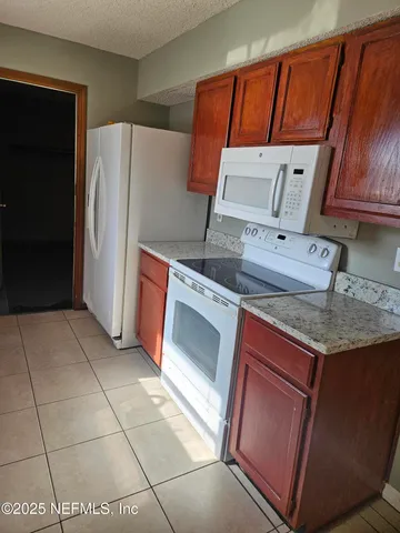 a kitchen with stainless steel appliances granite countertop a refrigerator a sink and dishwasher